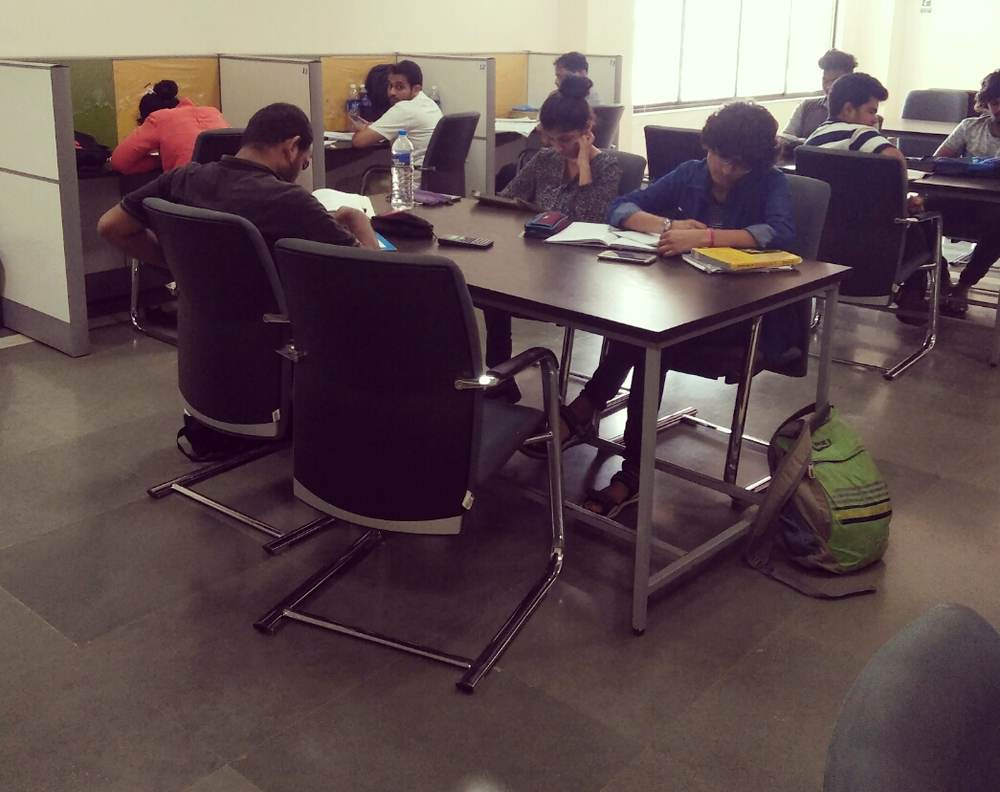 Students studying quietly at library desks